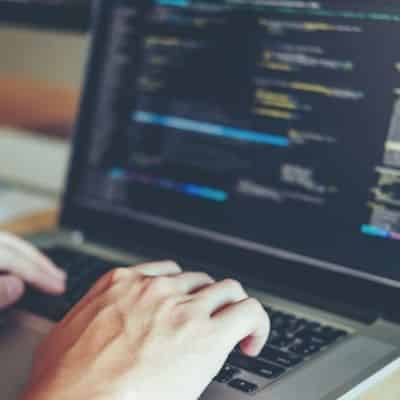 hands-typing-on-laptop-small Code on black background
